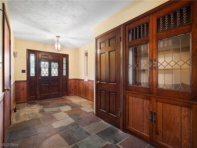 Tiled entryway featuring a textured ceiling