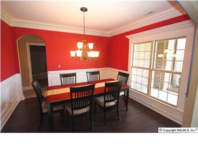 The formal dining room is trimmed to perfection with chair rail, beauty boxes, and dropped crown molding with rope lighting above it.
