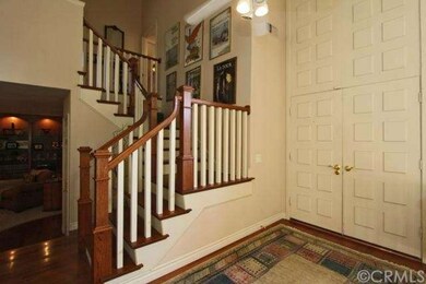Double door entry and hardwood flooring and stairs