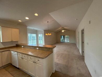 Kitchen featuring kitchen peninsula, white dishwas