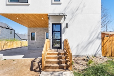 View of exterior entry with a patio area, fence, 
