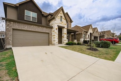 View of front of house with a front yard, an atta