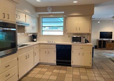 Kitchen overlooking backyard, patio and pool