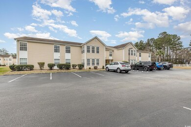 View of property with uncovered parking and a resi
