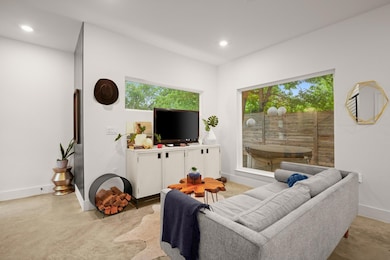 Living room featuring baseboards, concrete floors