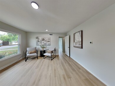 Sitting room with visible vents, light wood-style 