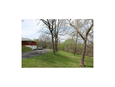 Side of home, many mature trees