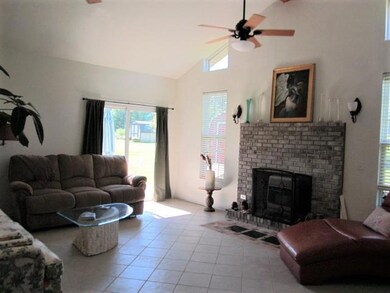 Den with tile floor, gas fireplace, vaulted ceiling w/2 ceiling fans