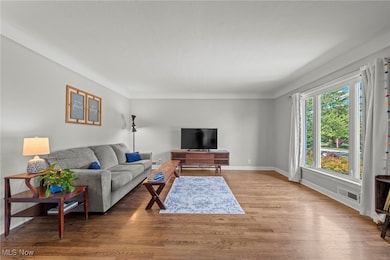 Living room featuring wood finished floors and baseboards