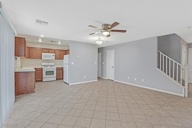 Unfurnished living room featuring ceiling fan, lig