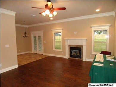 Family room has 10 foot ceilings, natural gas fireplace, wood flooring, ceiling fan, recessed lighting.