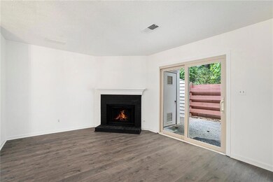 Unfurnished living room featuring dark wood-type f