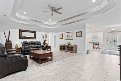 Living room featuring ceiling fan with notable cha