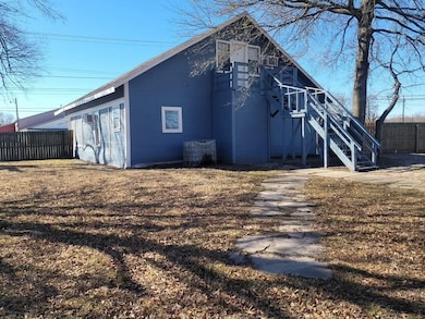 Back of house with fence and stairs