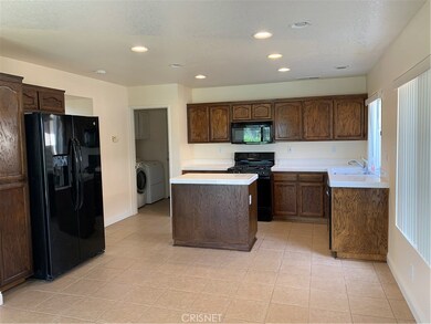 Kitchen cabinets with fresh stain, recessed lighting and lots of natural lighting