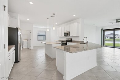 Kitchen with a sink, light tile patterned flooring