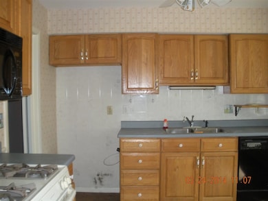 Eat in kitchen has updated cabinets and flooring.