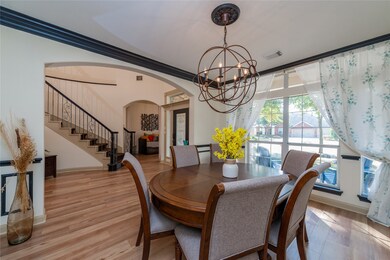Spacious formal dining area with a view of the front porch.