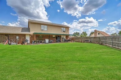 Back of property featuring a patio area and a yard