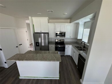 Kitchen with stainless steel appliances, a sink, a