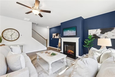Living area with stairway, wood finished floors, a