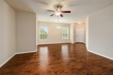 Empty room featuring baseboards, ceiling fan with