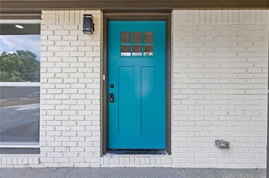 Entrance to property featuring brick siding