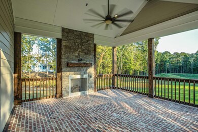 Tranquil and serene covered porch with fireplace.