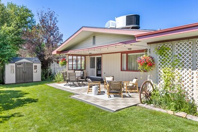 Rear view of house featuring a shed and a patio area