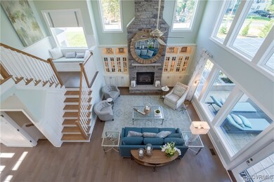 Living room featuring a stone fireplace, a wealth