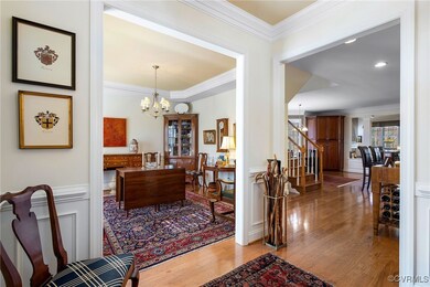 Entrance foyer with crown molding, a notable chand