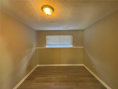 Empty room featuring baseboards, visible vents, wo