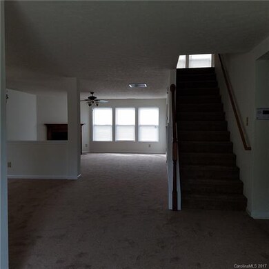 VIEW FROM FOYER TO DINING AREA, STAIRS AND FAMILY 