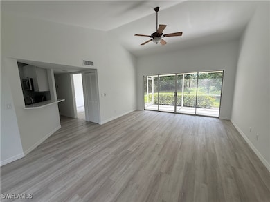 Unfurnished living room with light wood finished floors, high vaulted ceiling, and a ceiling fan