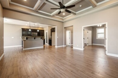 Unfurnished living room featuring coffered ceiling