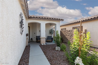 Doorway to property with stucco siding and a tiled