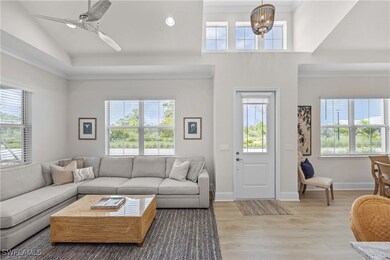 Living room with ceiling fan with notable chandeli