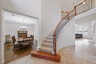 a grand staircase sets the tone at the entry, lead