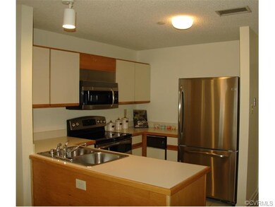 Kitchen with GE Profile Refrigerator, Range, and D
