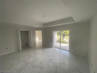 Spare room with a tray ceiling and light tile floors