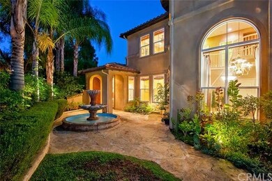 Front porch w/ water fountain and lots of palm tre