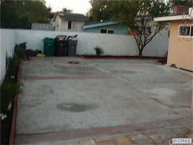 Large Back Yard With Palm Trees and Flowers Around