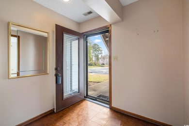 Entrance foyer with tile patterned flooring, visib