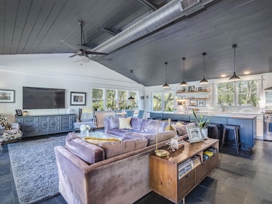 Living room with vaulted ceiling and wooden ceiling