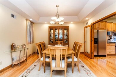 The dining room features a tray ceiling accented w