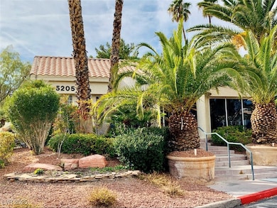 View of front of home with stucco siding and a til