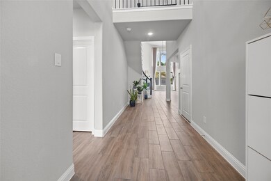 As you enter, you're greeted by a high-ceiling entrance foyer that seamlessly flows into the expansive living room.