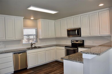 Kitchen featuring white  Cabinets, backsplash, lots of counter space!