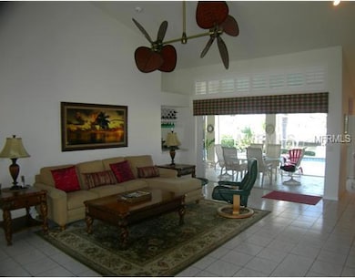 Living Room - Tile flooring, vaulted ceilings, double paddle fan, sliders to pool and lanai.