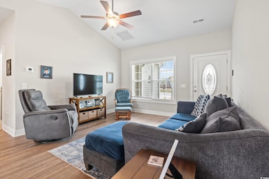 Living area with visible vents, baseboards, ceilin